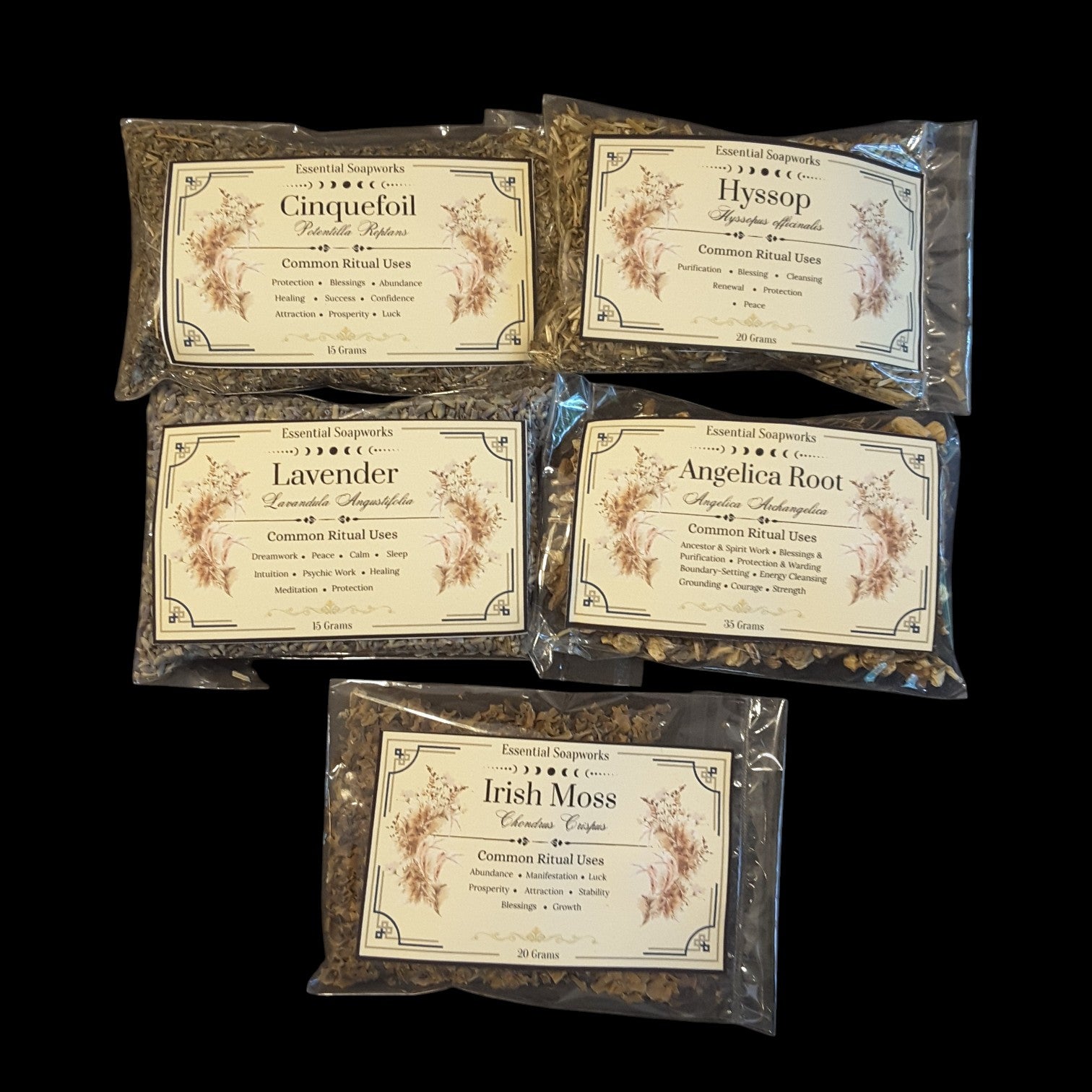 Five clear plastic bags of blessings herbs for witchcraft arranged on a black background. The labels read Cinquefoil, Hyssop, Lavender, Angelica Root, and Irish Moss, with botanical illustrations on the cream-colored labels.