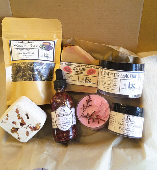Collection of skincare and wellness products from Essential Soapworks on brown paper