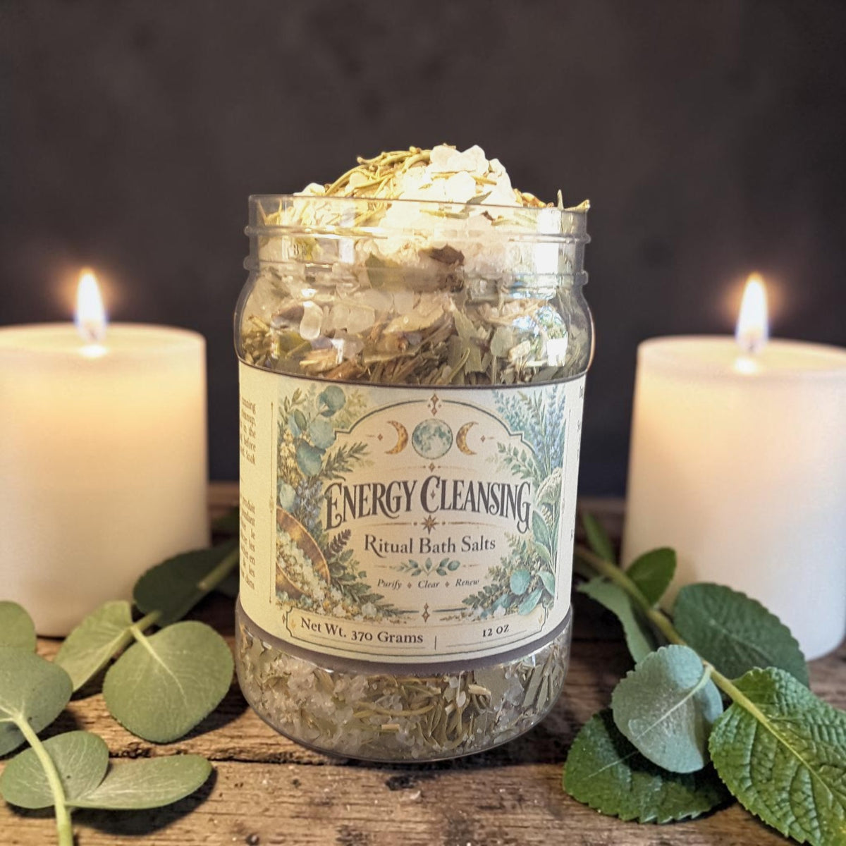 energy cleansing bath salts in a jar on a dark wooden surface with mint leaves and candles