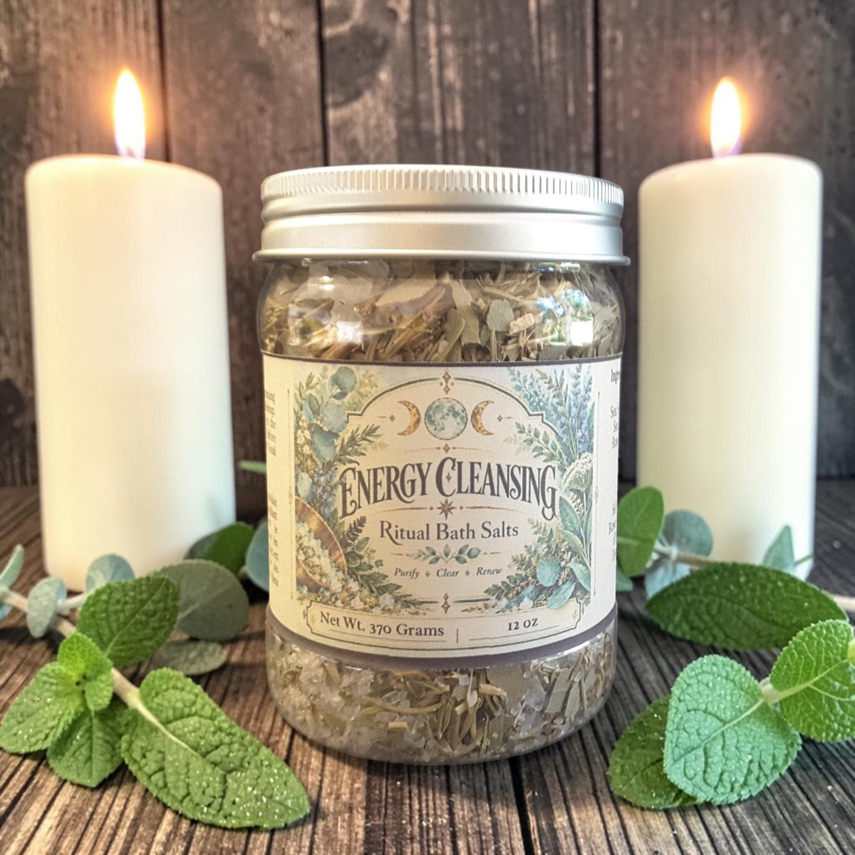 energy cleansing bath salts in a jar on a dark wooden surface with mint leaves and candles