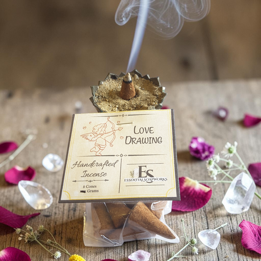 Love-drawing incense cone on a wooden surface with flowers and crystals