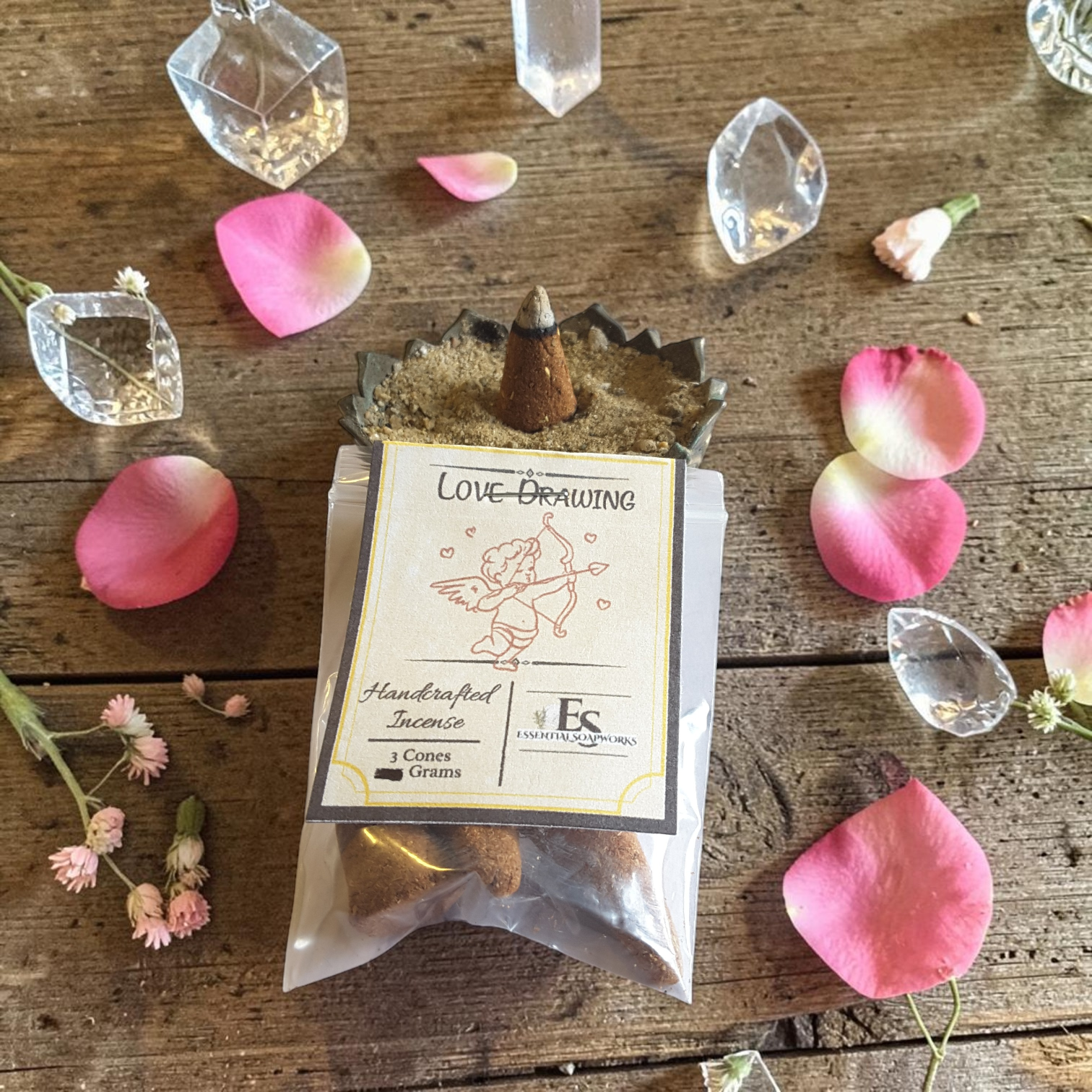 Handcrafted love-drawing incense cones with decorative elements on a wooden surface