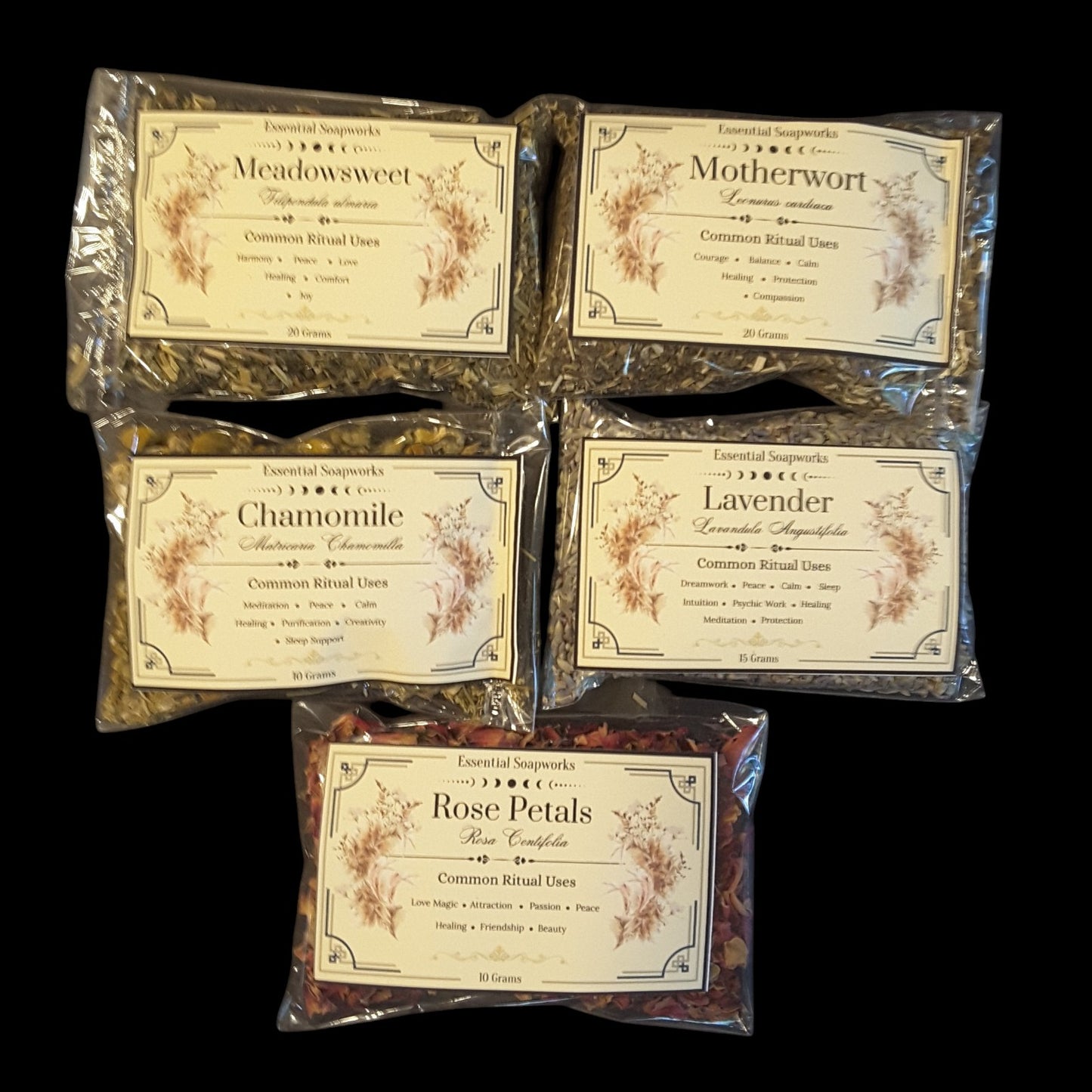 Five clear plastic bags of witchy ritual herbs and flowers arranged on a black background. The bags feature vintage-style cream labels with floral illustrations and text including Meadowsweet, Motherwort, Chamomile, Lavender, and Rose Petals.