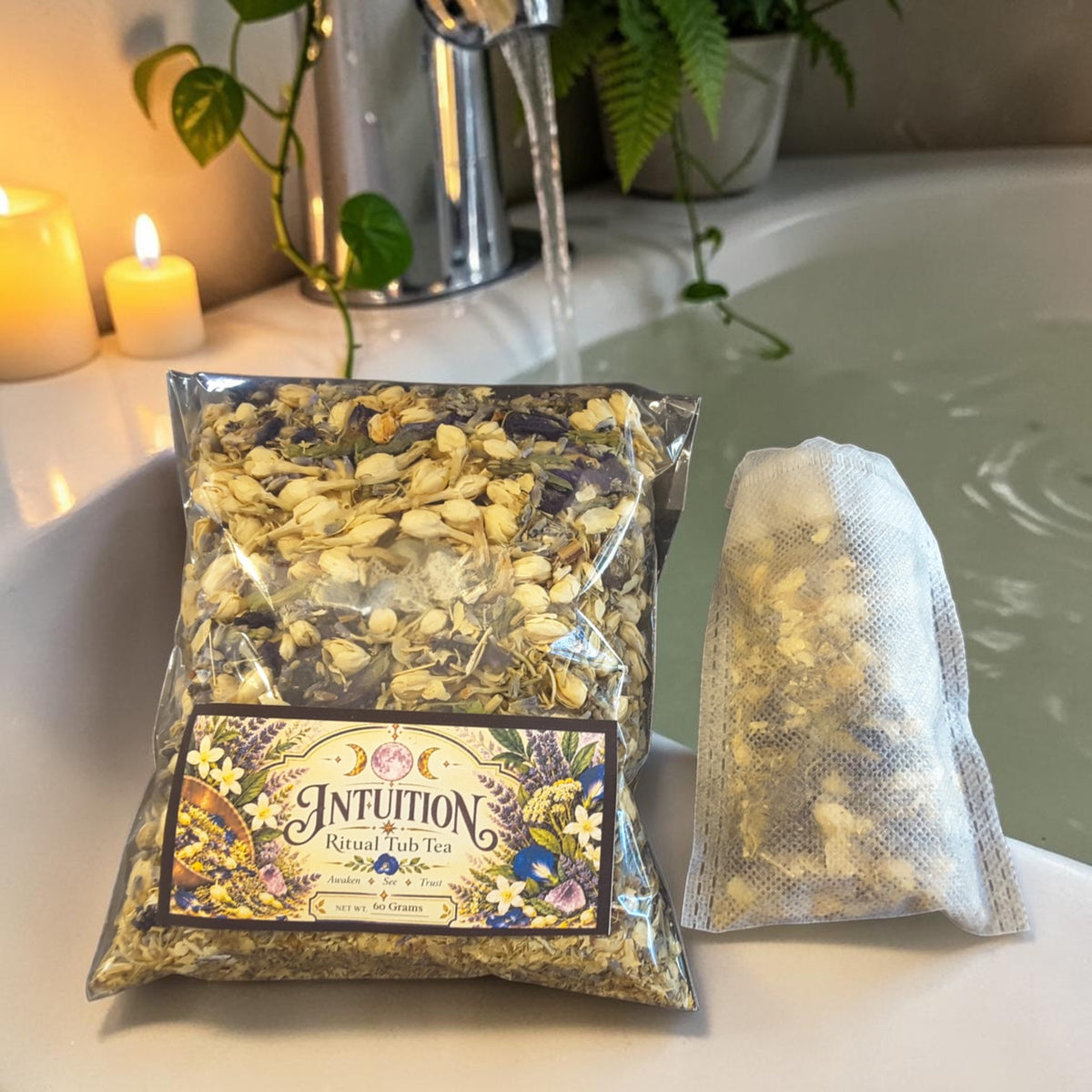 intuition tub tea on the ledge of a bathtub with plants and candles in the background
