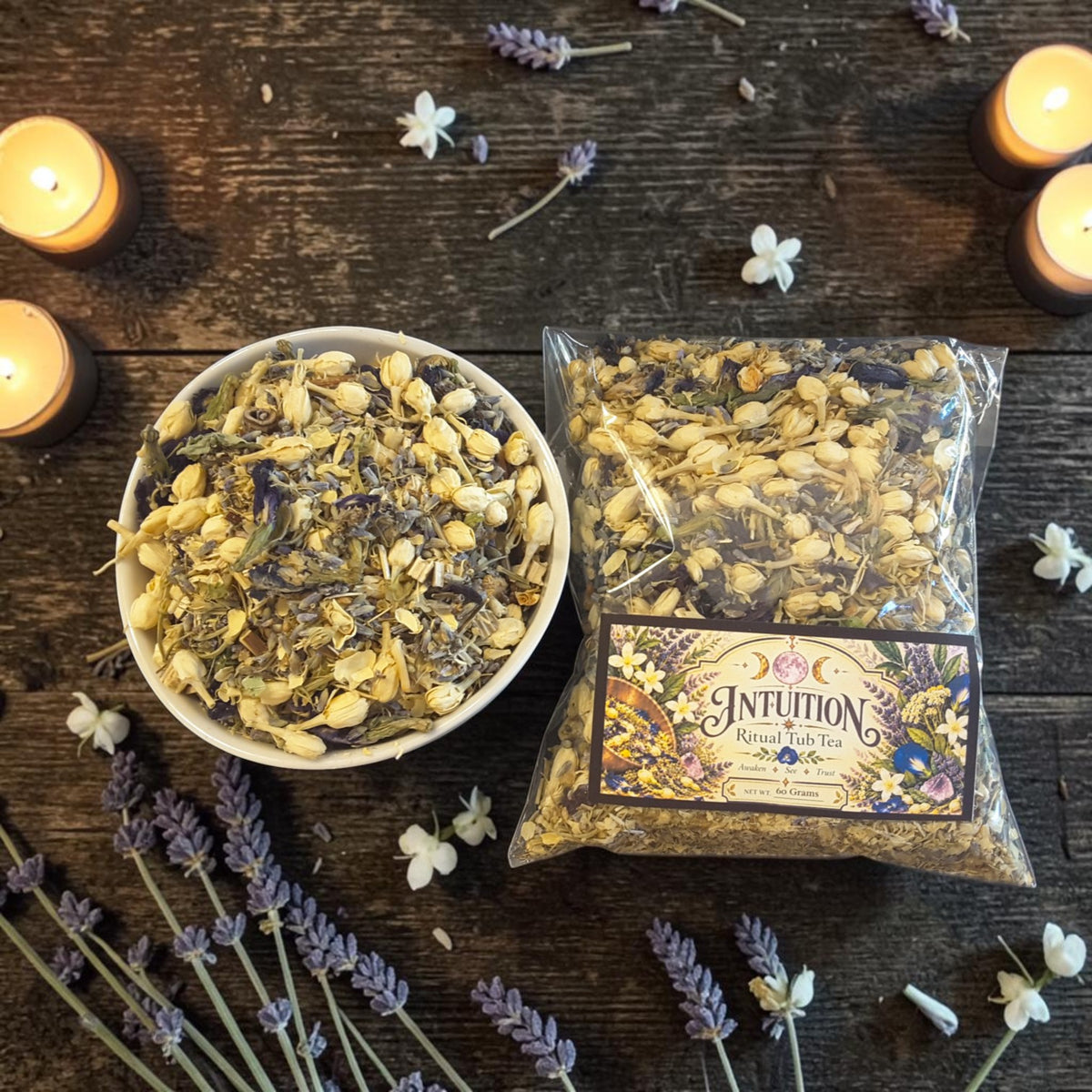intuition tub tea on a dark wooden surface with jasmine, lavender and candles