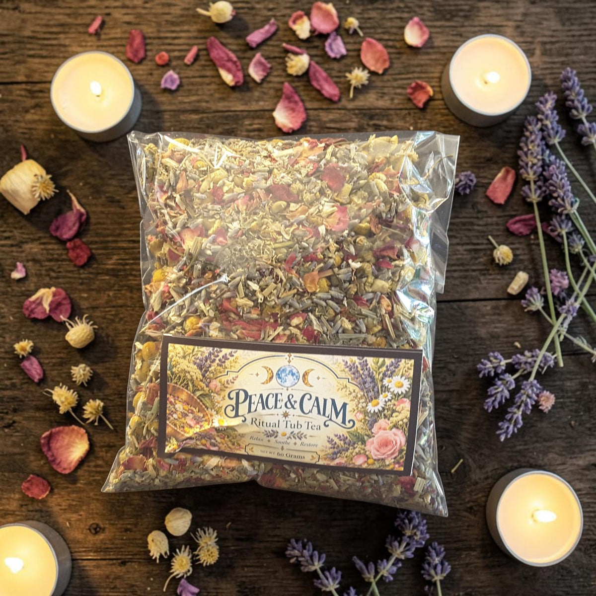 peace and calm herbal tub tea on a wooden surface with candles, lavender and red rose petals