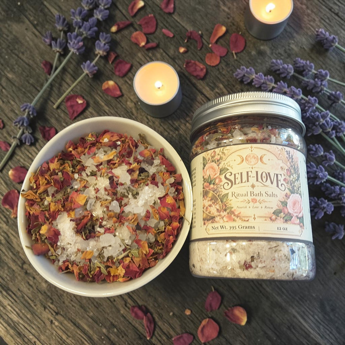 self-love bath salts in a jar and in a bowl on a wooden surface with lavender, roses and candles