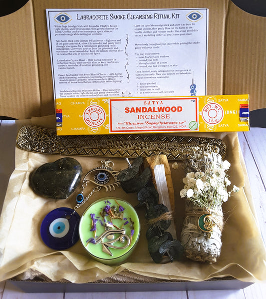 labradorite smudge kit with labradorite crystal, white sage smudge stick, sandalwood incense, evil eye talisman and palo santo in a kraft box