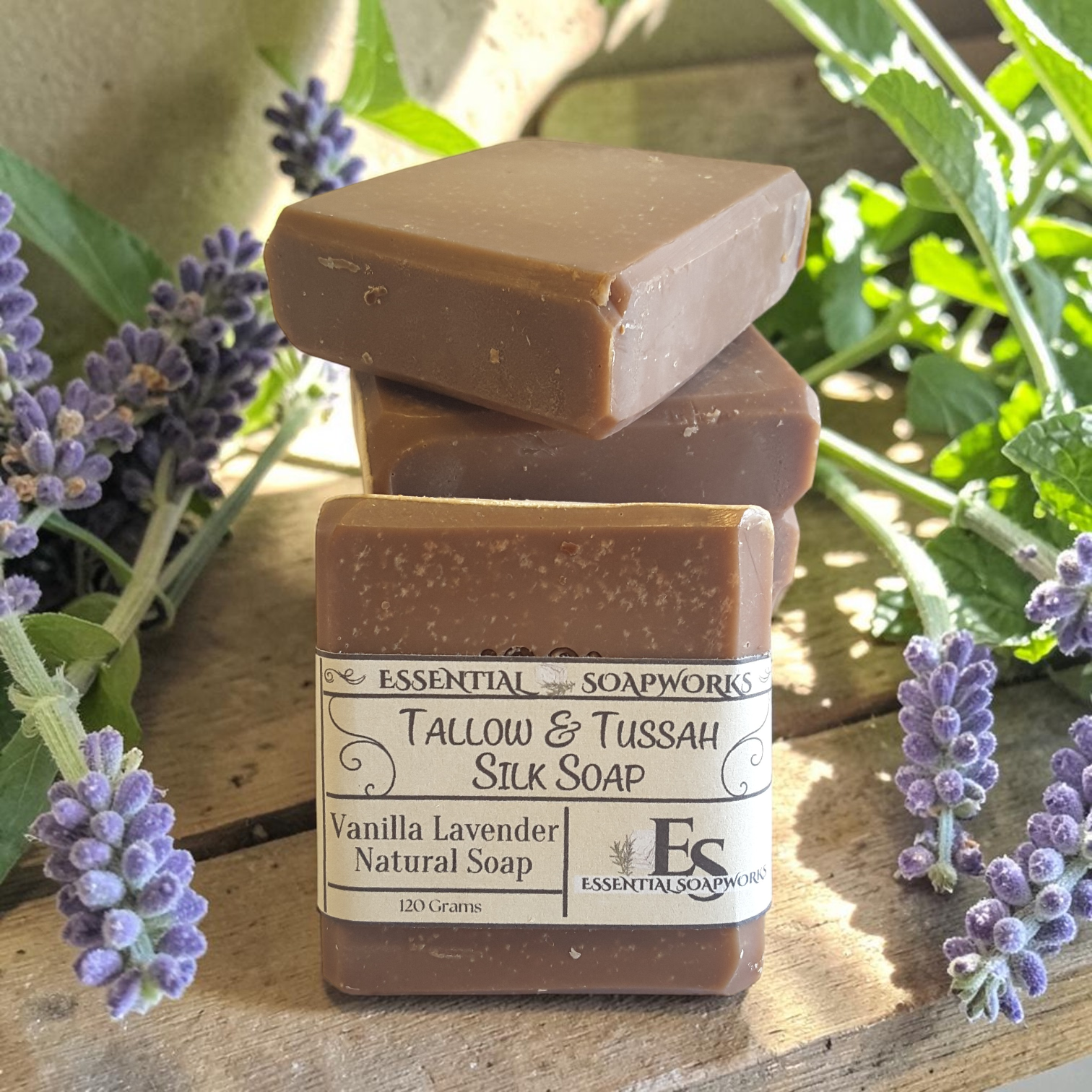 vanilla lavender tallow soap on a wooden surface with lavender flowers