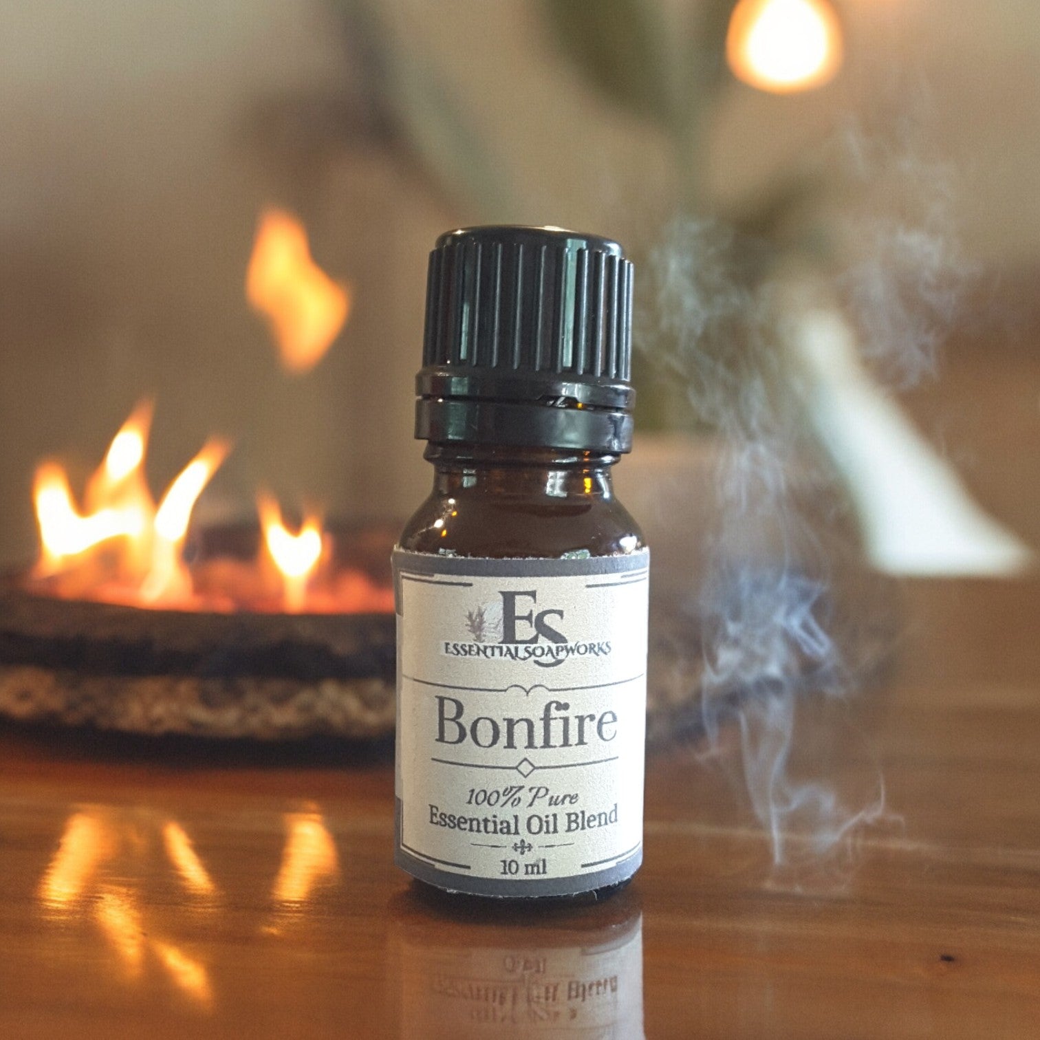 Bottle of 'Bonfire' essential oil blend on a wooden surface with a fireplace in the background