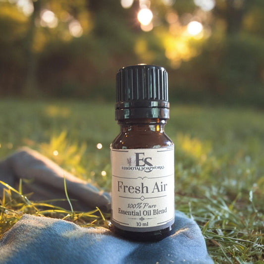 Bottle of Fresh Air Essential Oil Diffuser Blend on a blue towel with a natural background