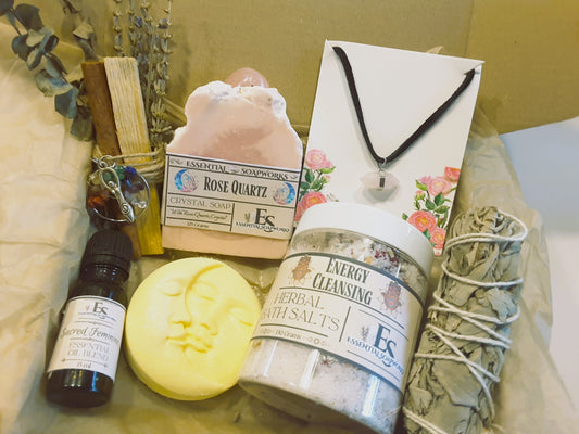 Collection of wellness and self-care products including a bottle, soap, and salt on a textured surface.