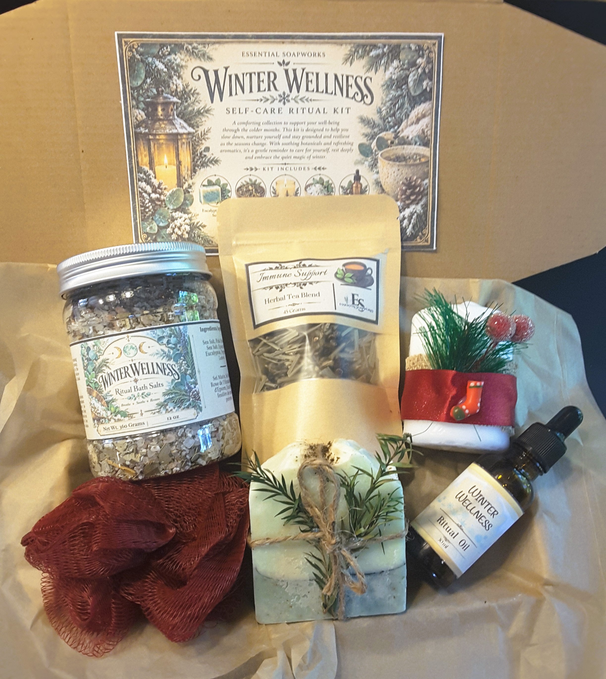 winter wellness christmas spa gift set featuring handcrafted artisan eucalyptus mint soap, immunity tea blend, herbal bath salts, ritual oil, festive candle and loofah arranged in a kraft box